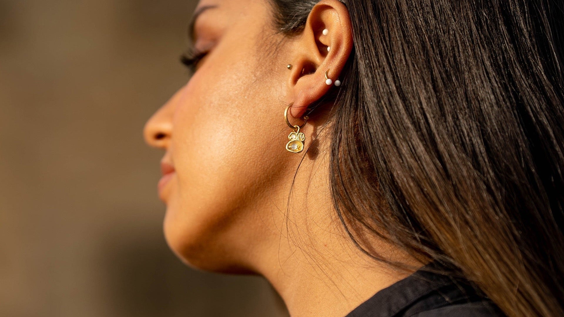 Model wears moonstone gold hoop earrings