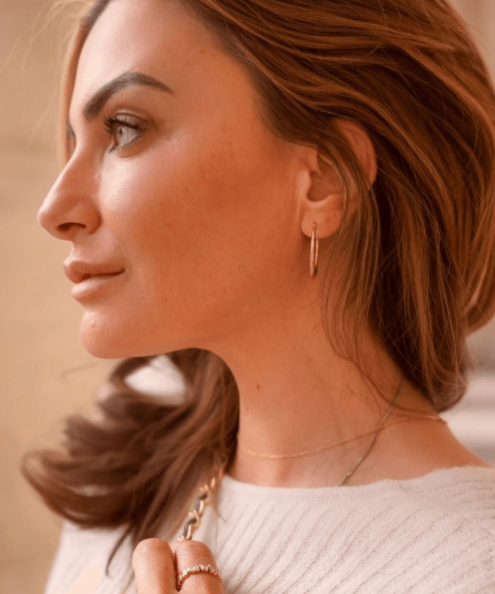 Lorna Jayne wears baguette gold ring and large 9ct solid gold hoop earrings