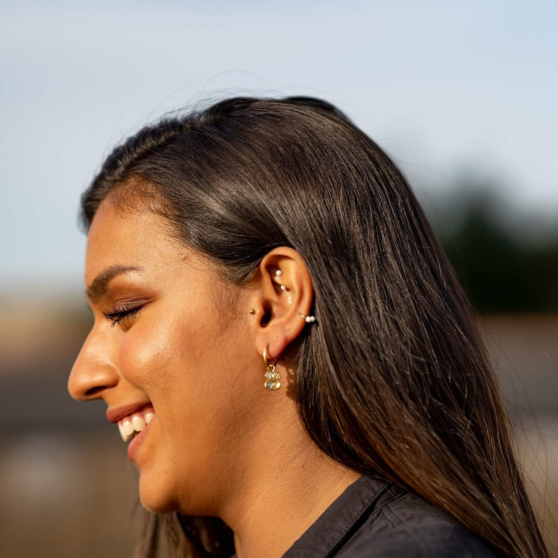 model-wears-14k-gold-vermeil-and-aquamarine-birthstone-hoop-earrings-claire-hill-designs