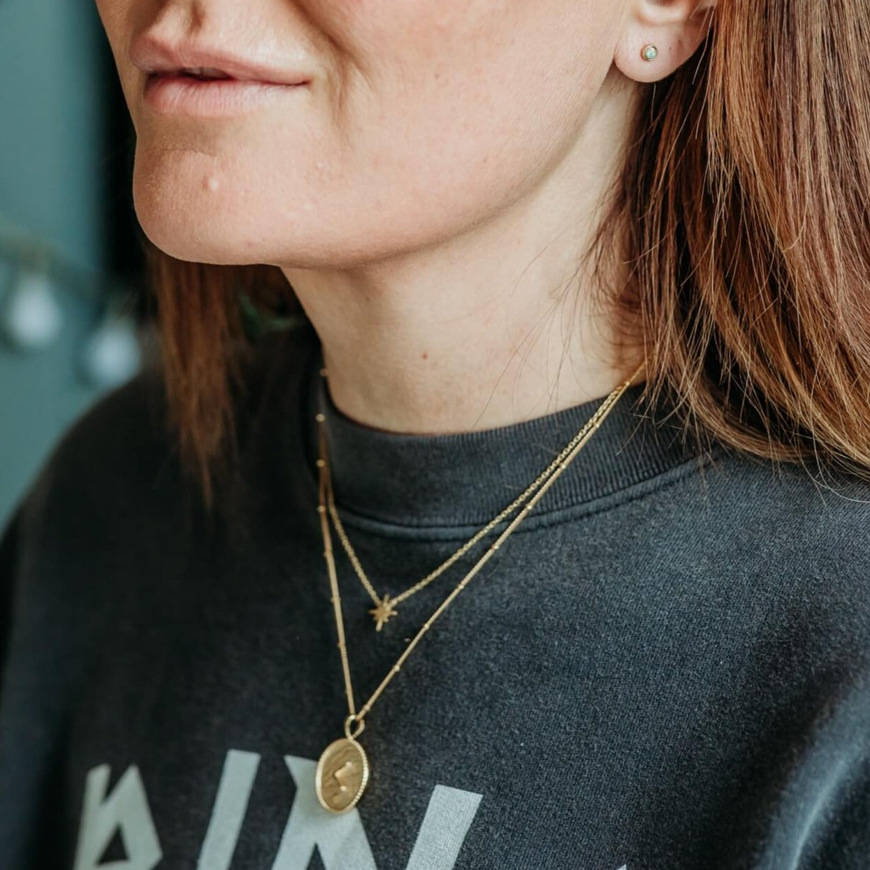 model-wears-14k-gold-vermeil-kind-shorthand-coin-disc-necklace-and-gold-vermeil-brushed-star-dainty-necklace-and-opal-stud-earrings-claire-hill-designs