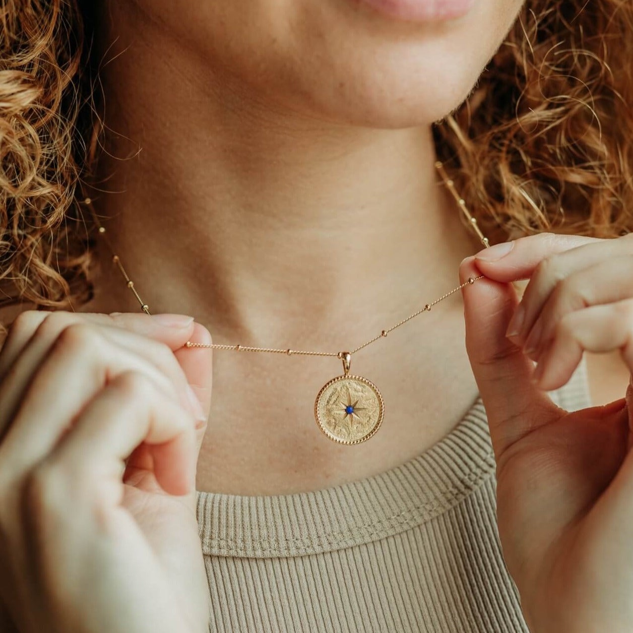 model-wears-14k-gold-vermeil-north-star-pendant-necklace-with-lapis-lazuli-claire-hill-designs-close-up