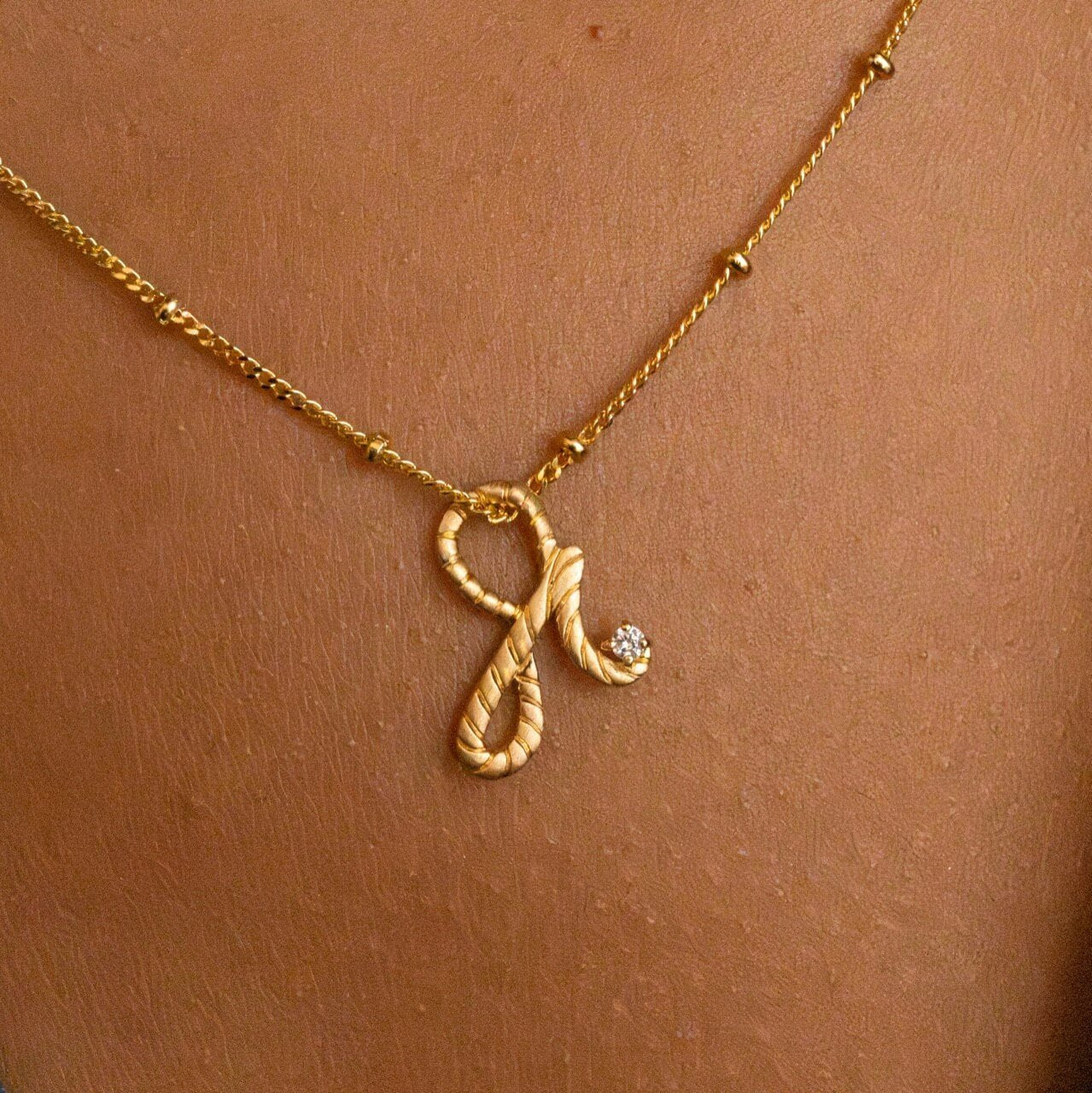 model wears 14k Gold Vermeil Shorthand Charm on Satellite Beaded Chain Necklace meaning Fearless - Claire Hill Designs