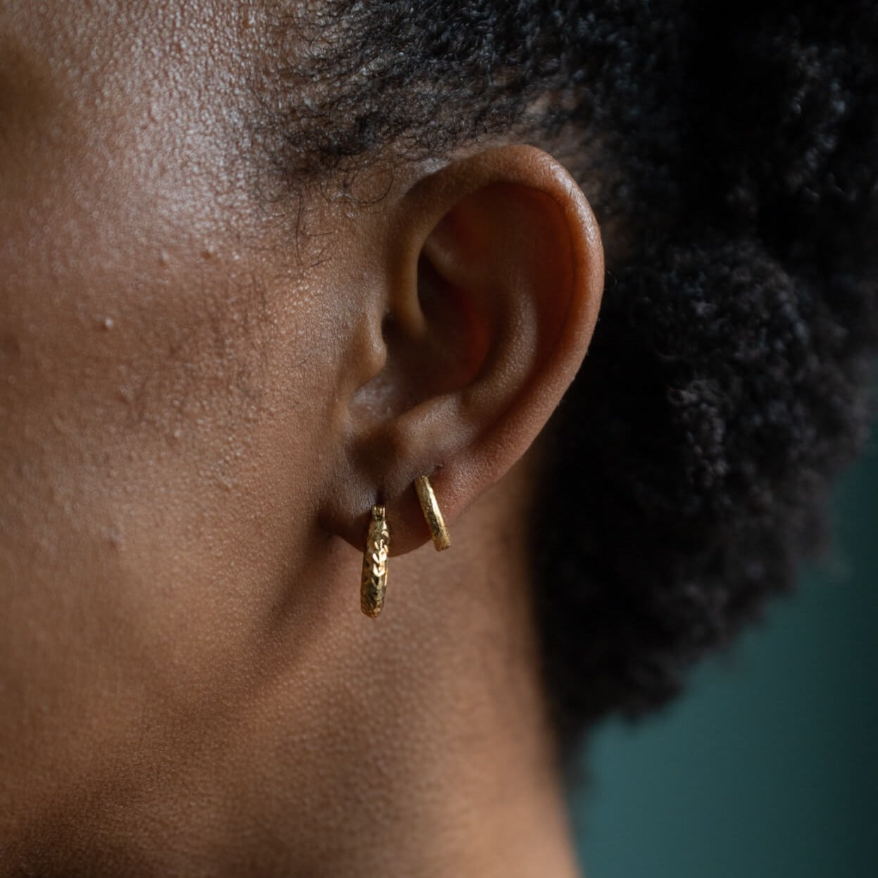 model wears  Chunky diamond cut 18k gold vermeil hoop earrings