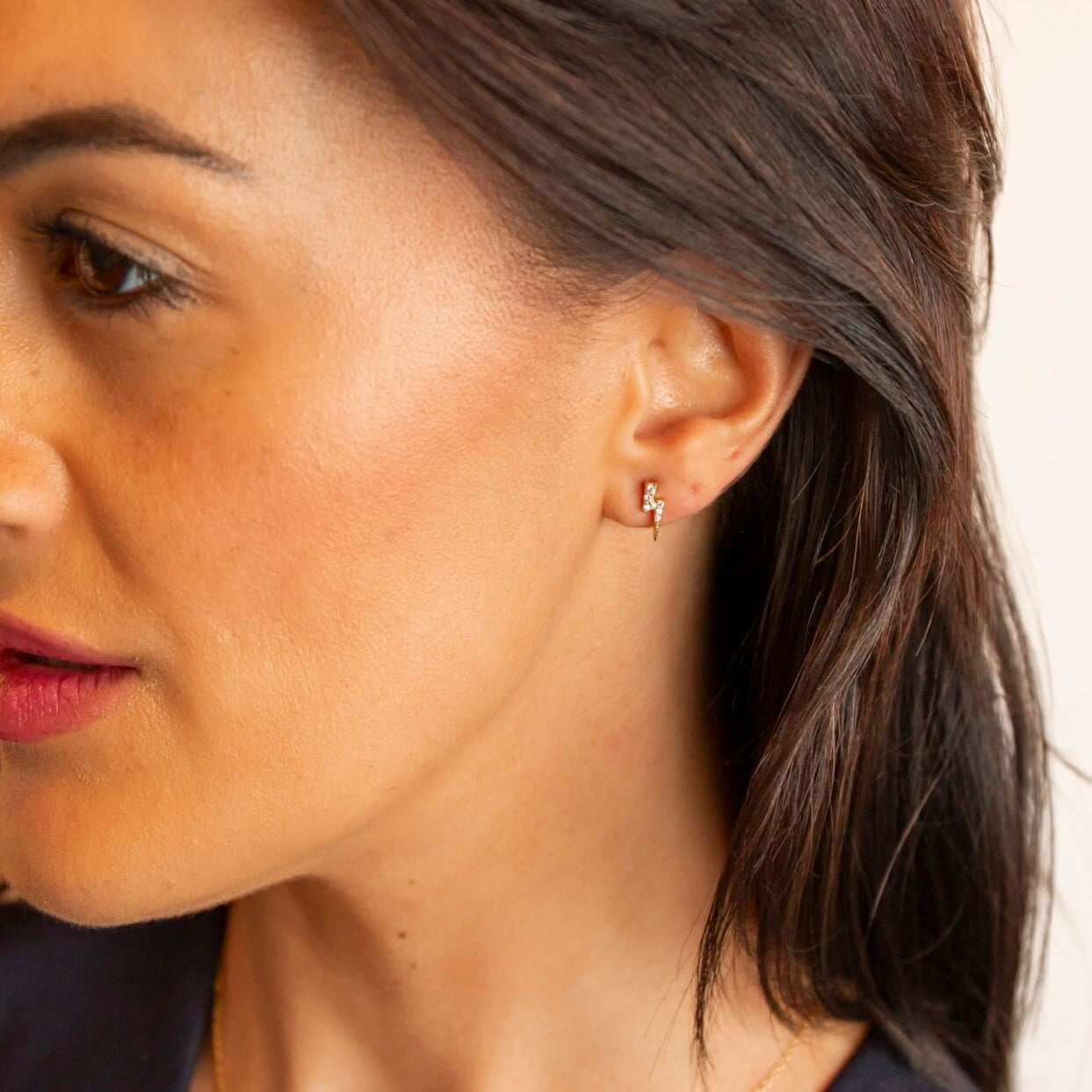 model wears Sparkly Gold Lightning Bolt Stud Earrings