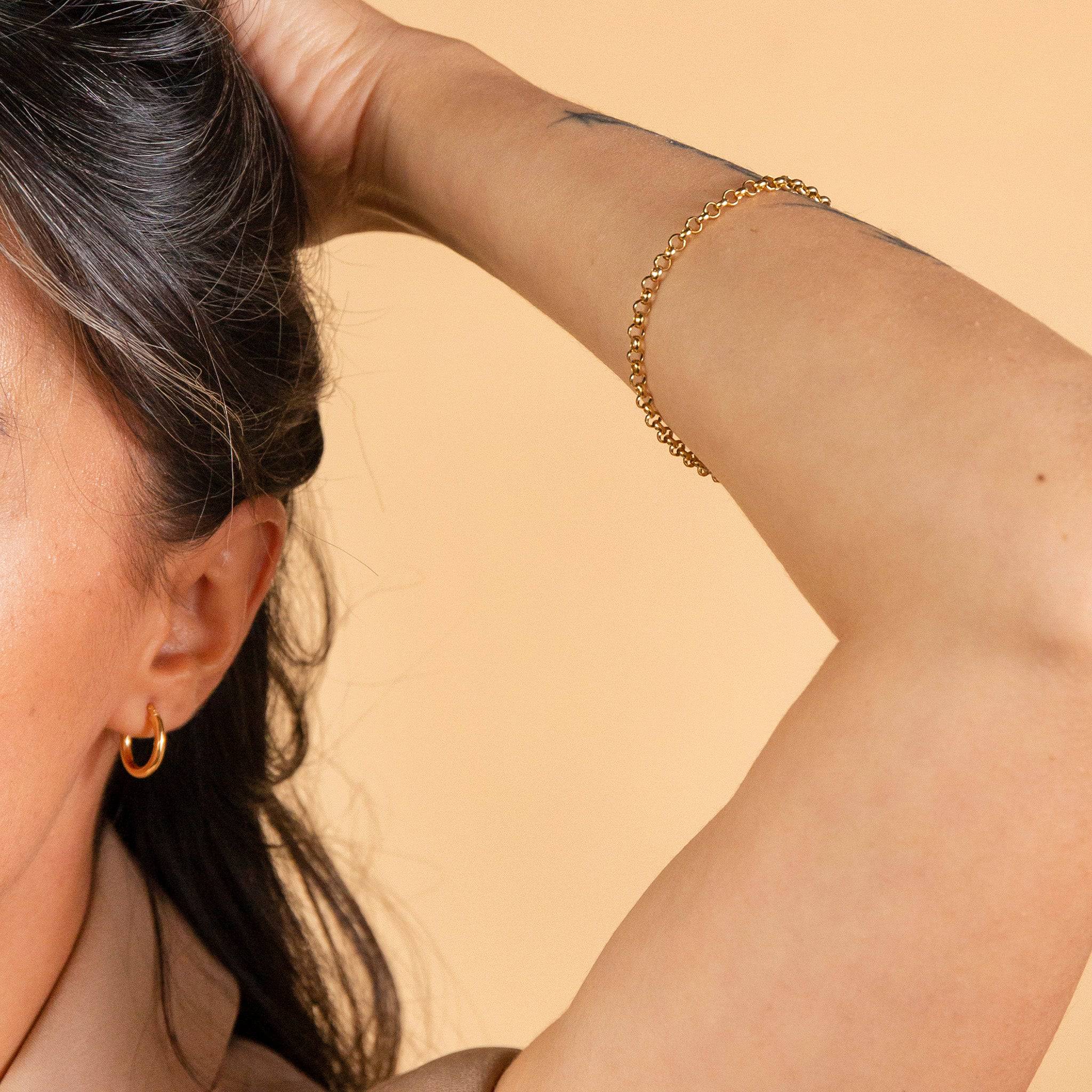 model wears 9ct Solid Gold Hoop Earrings (15mm)