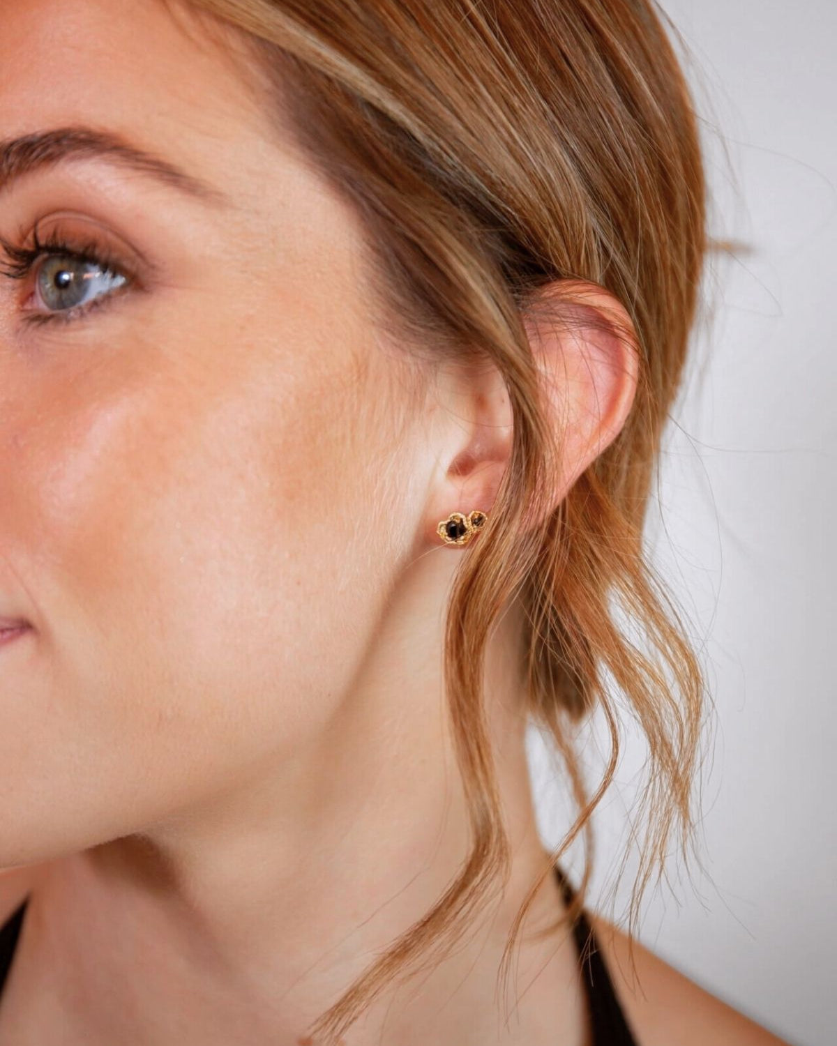 model wears black spinel lichen double gold climber stud earrings