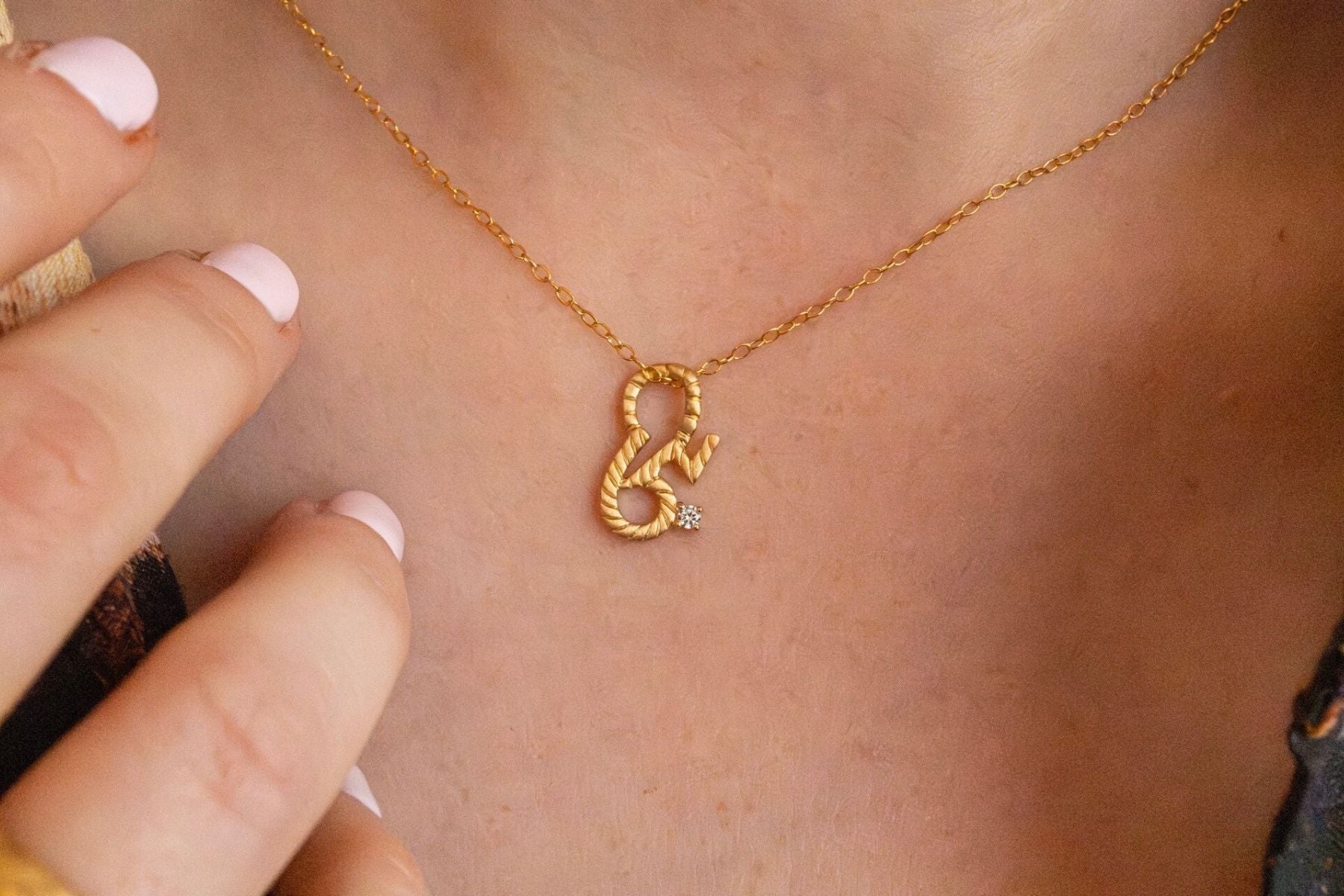 model wears Brave Gold Shorthand Charm Necklace