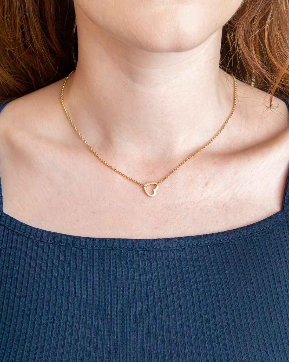 model wears brushed heart connector necklace