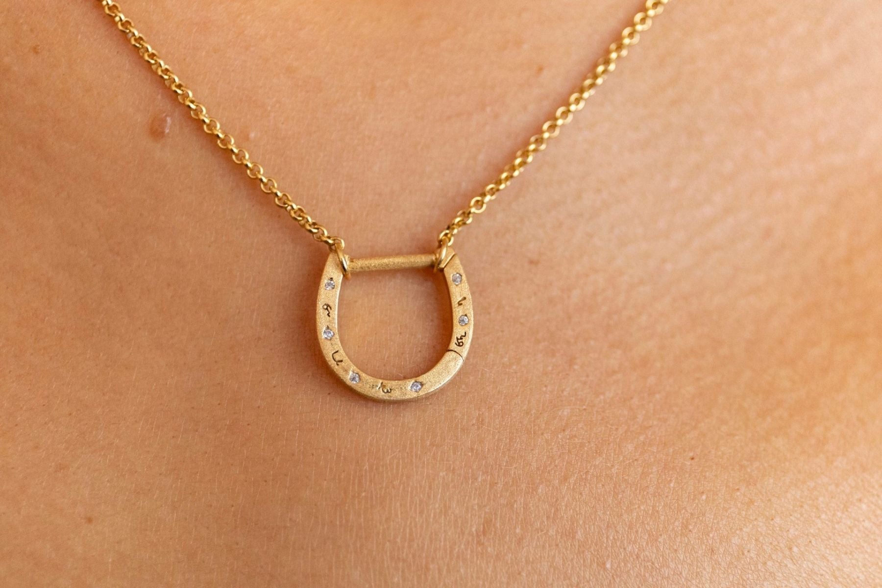 model wears Sparkly Gold Horseshoe Necklace