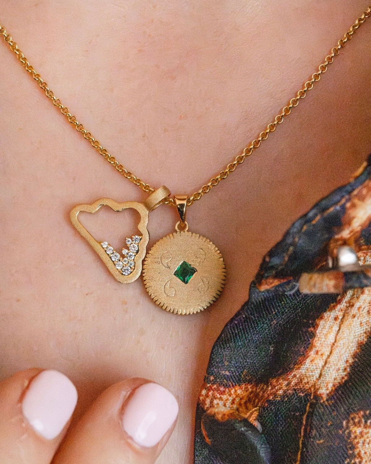 model-wears-gold-lovespoon-charm-and-sparkly-cloud-charm-necklace-