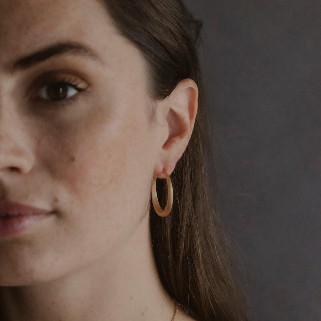 Model wears large 30mm gold vermeil brushed hoop earrings