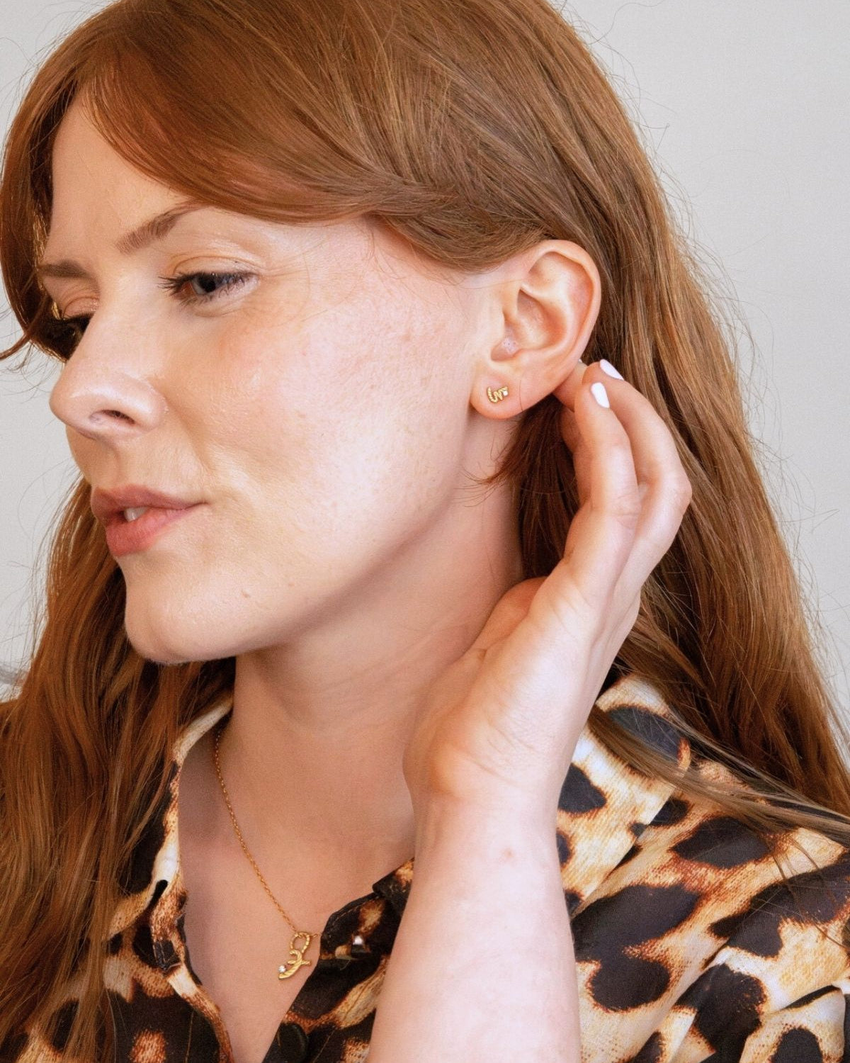 model wears Loved Gold Shorthand Stud Earring