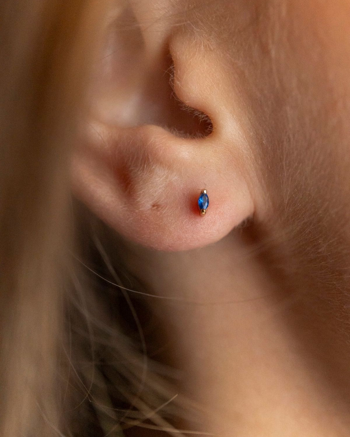 model wears Sapphire Cubic Zirconia Gold Labret Earring