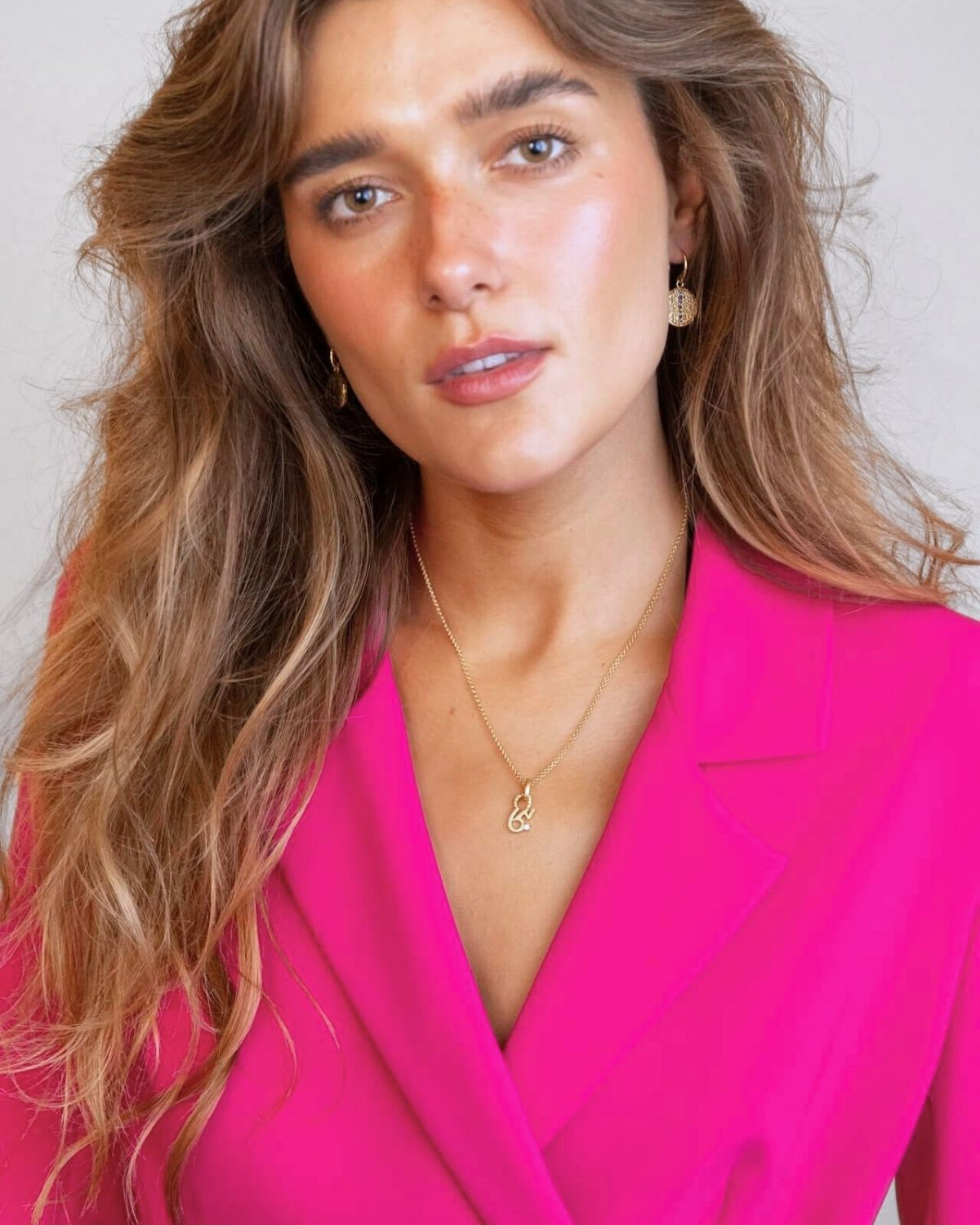 model wears sapphire gold coin drop earrings and brave gold necklace