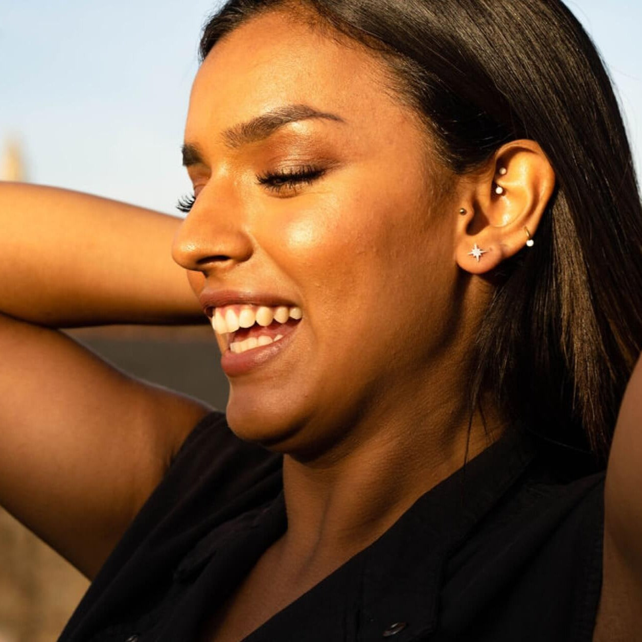 model wears silver brushed north star stud earrings