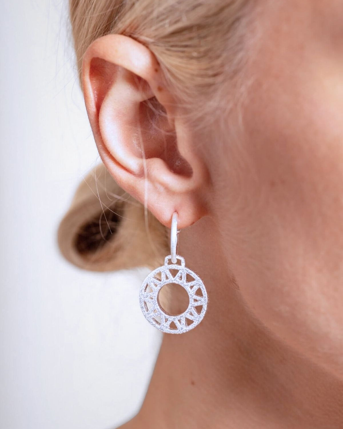 model wears Geometric Statement Silver Hoop Earrings
