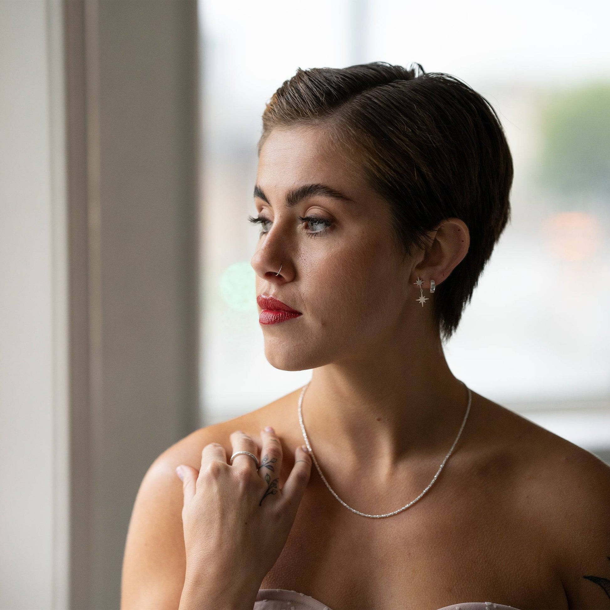 model wears Stardust Layering Chain Silver Necklace and silver star earrings