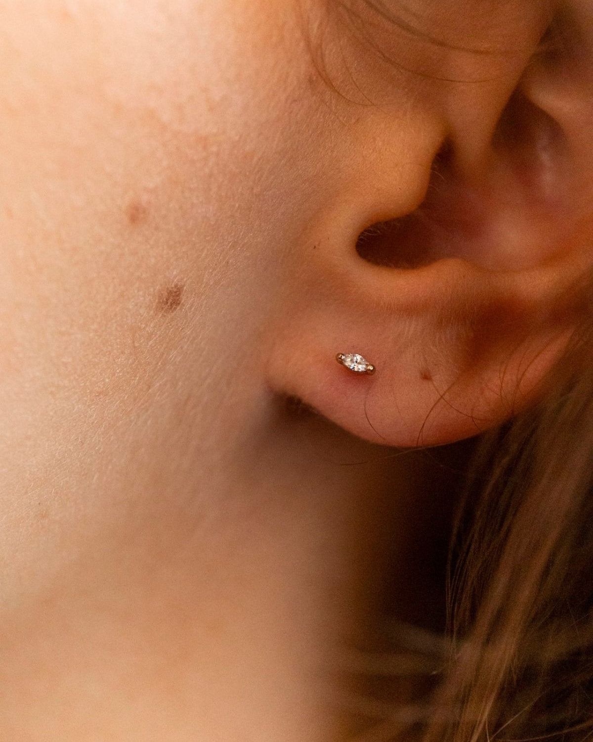 model wears Clear Cubic Zirconia Gold Labret Earring