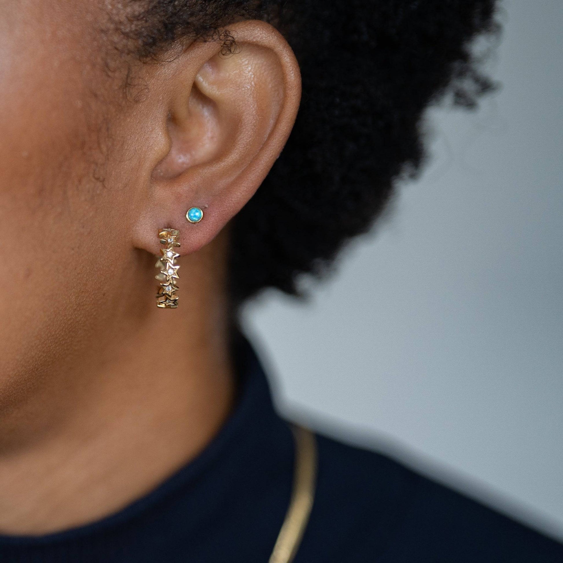 model wears Sparkly Star Statement Gold Hoop Earrings