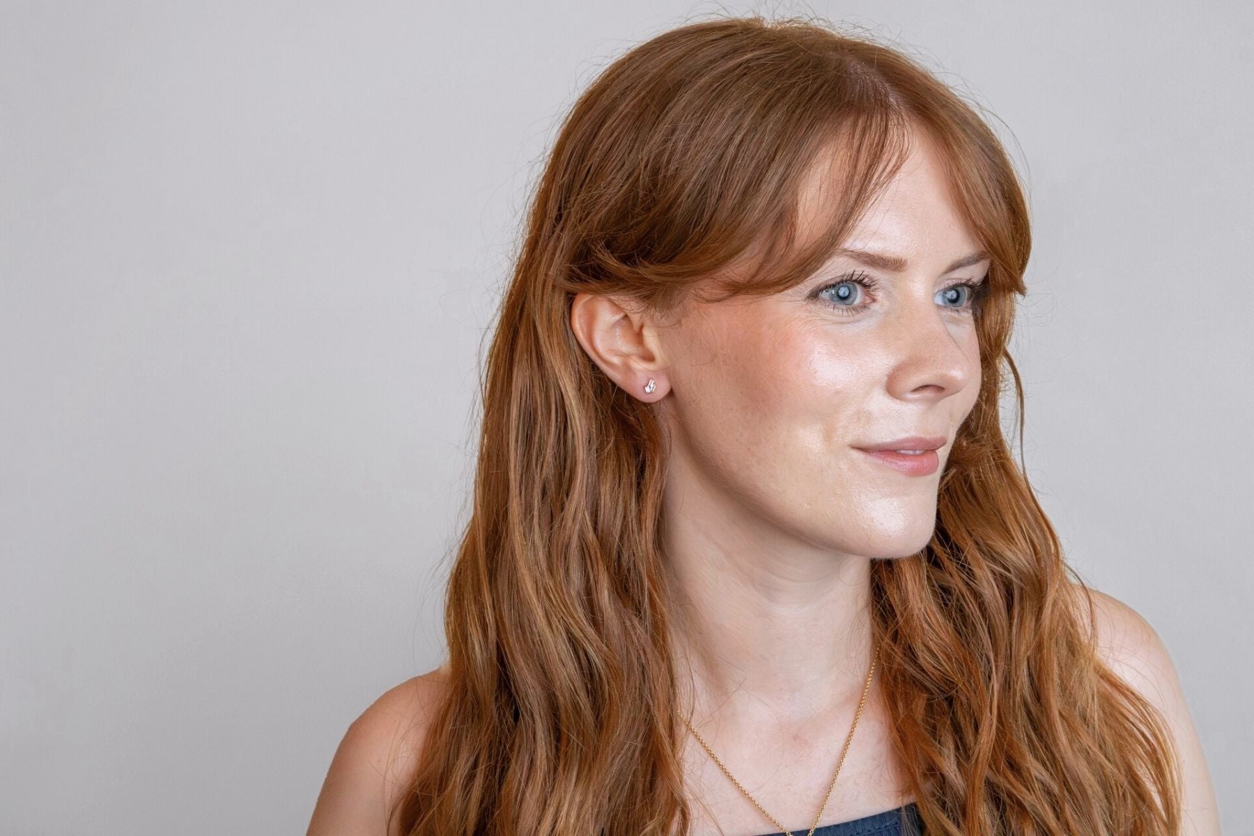 model wears Triple Cubic Zirconia Gold Labret Earring