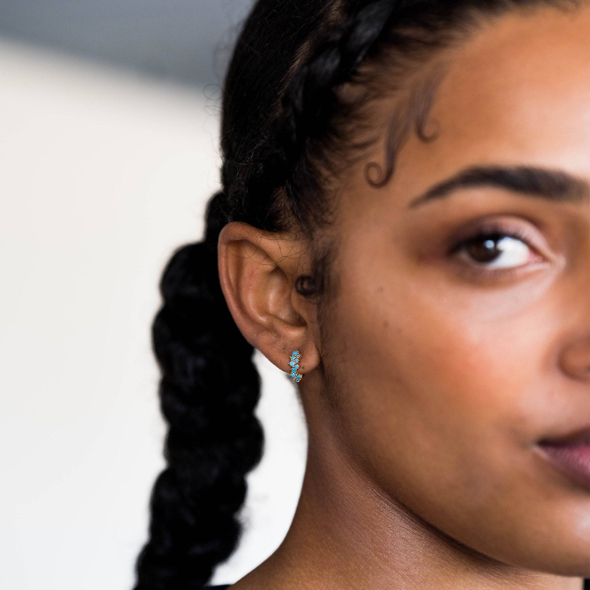 model wears Turquoise Gold Galaxy Scatter Huggie Hoop Earrings