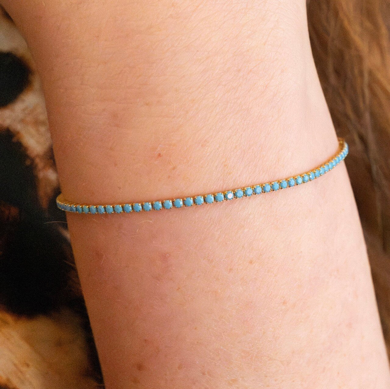 model wears turquoise 18k gold vermeil tennis bracelet