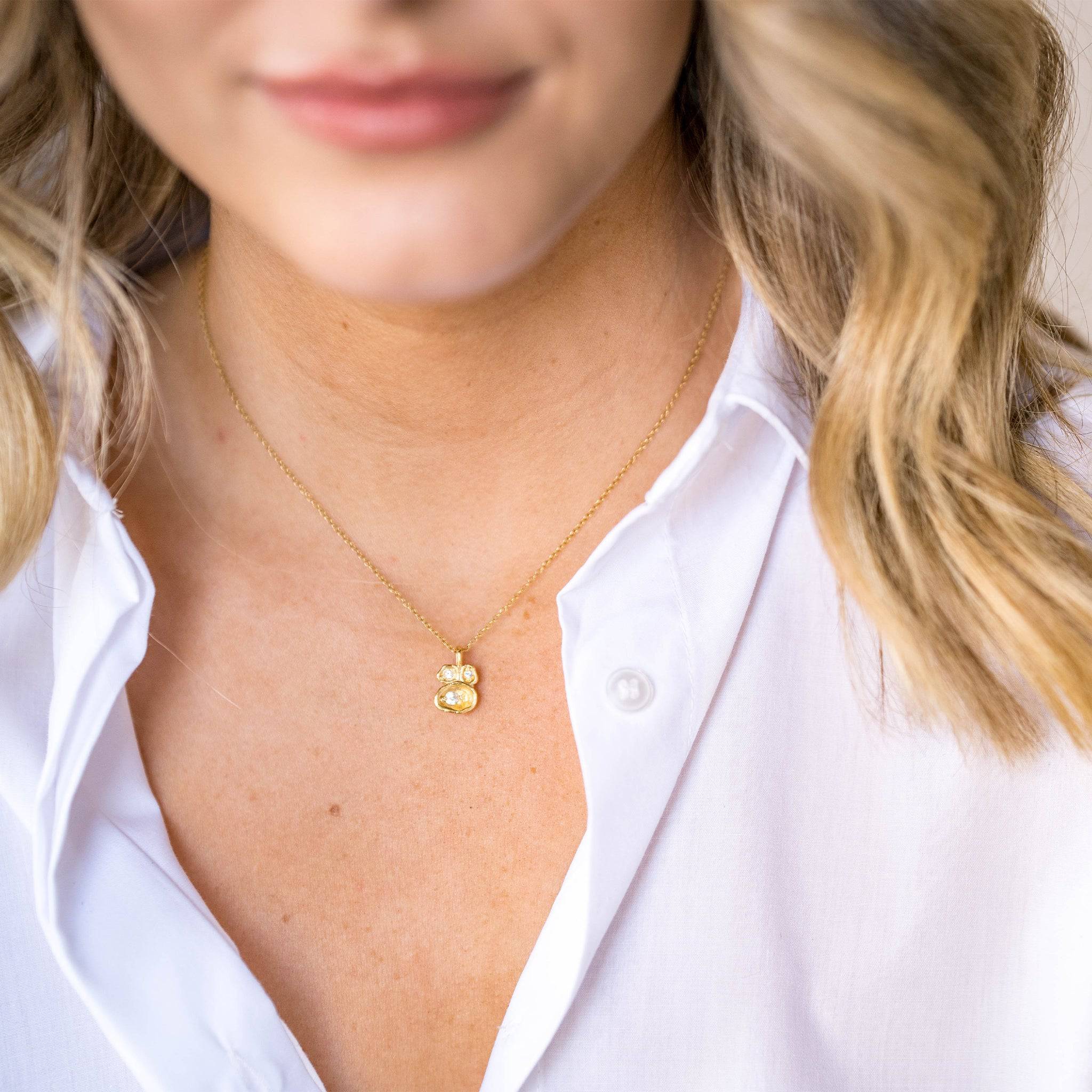 model wears White Topaz and Gold Lichen Pendant Necklace