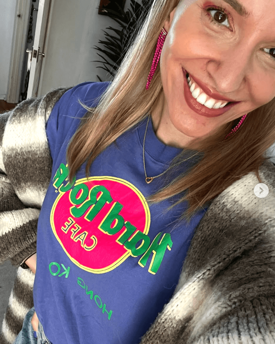 Stelu wears gold heart connector charm necklace