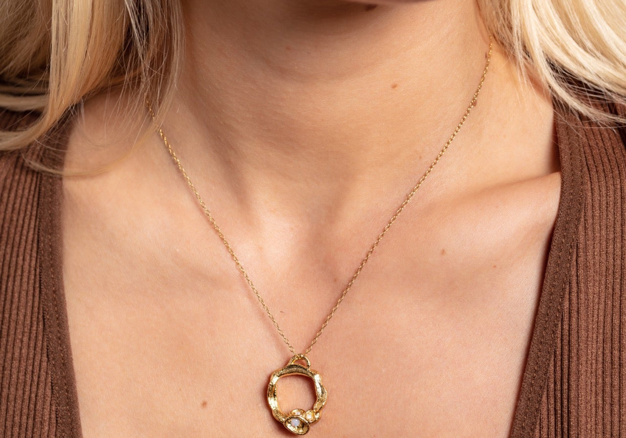 Model wears gold vermeil opal birthstone necklace