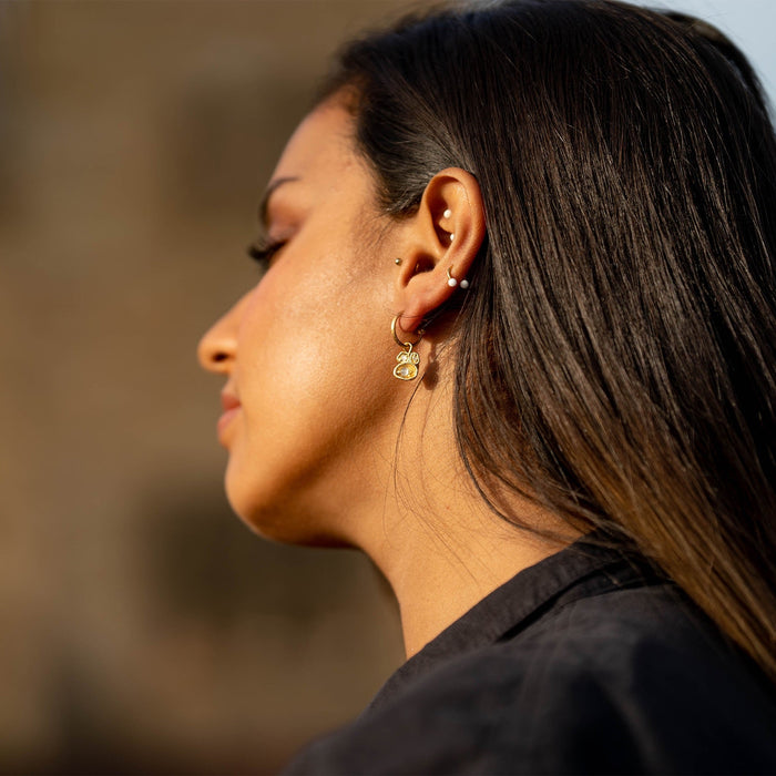 Model wears moonstone gold hoop earrings
