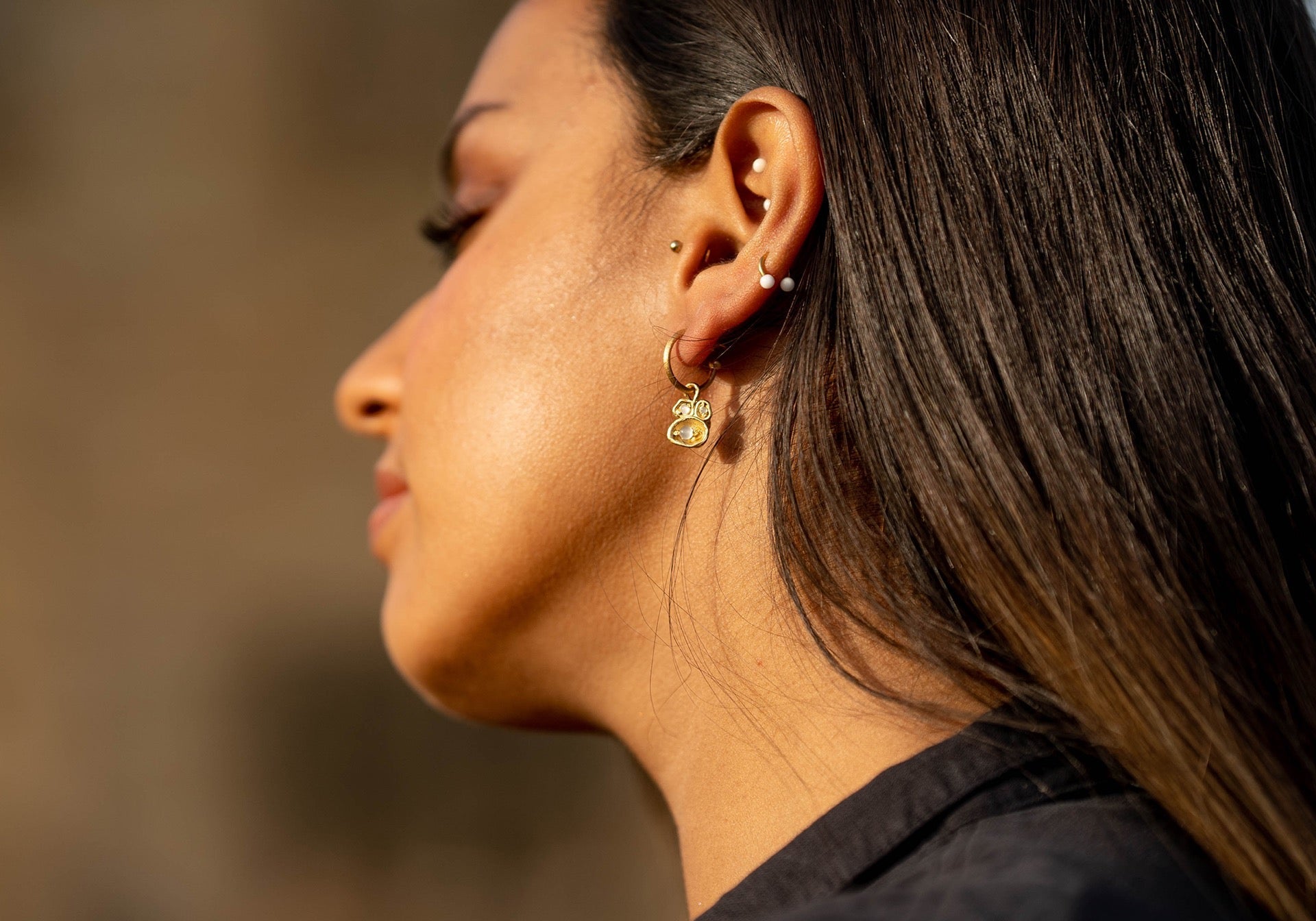 Model wears moonstone gold hoop earrings