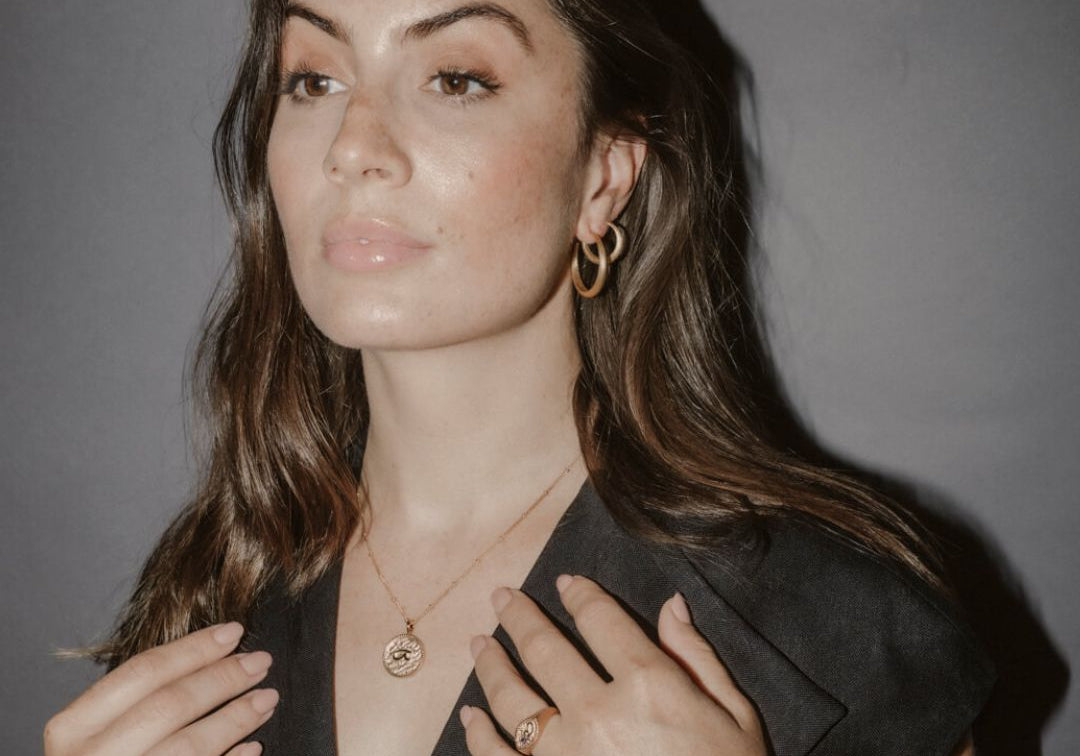Model wears large gold hoops