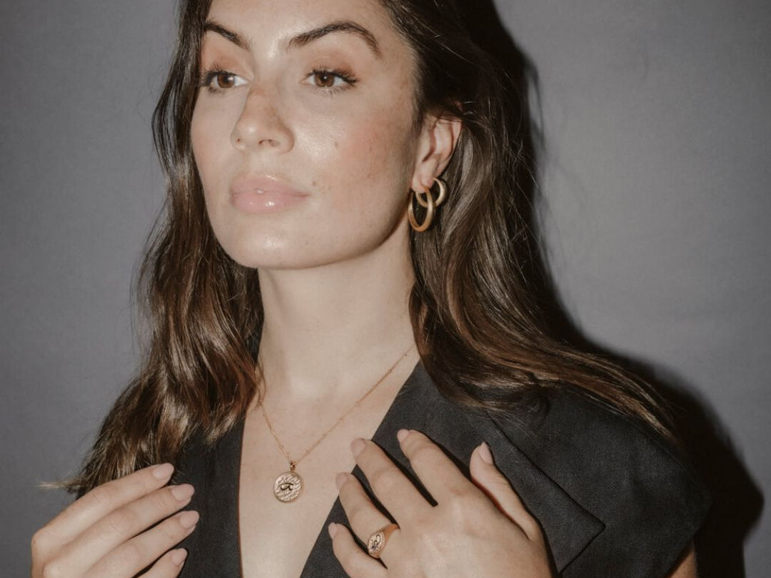 Model wears large gold hoops