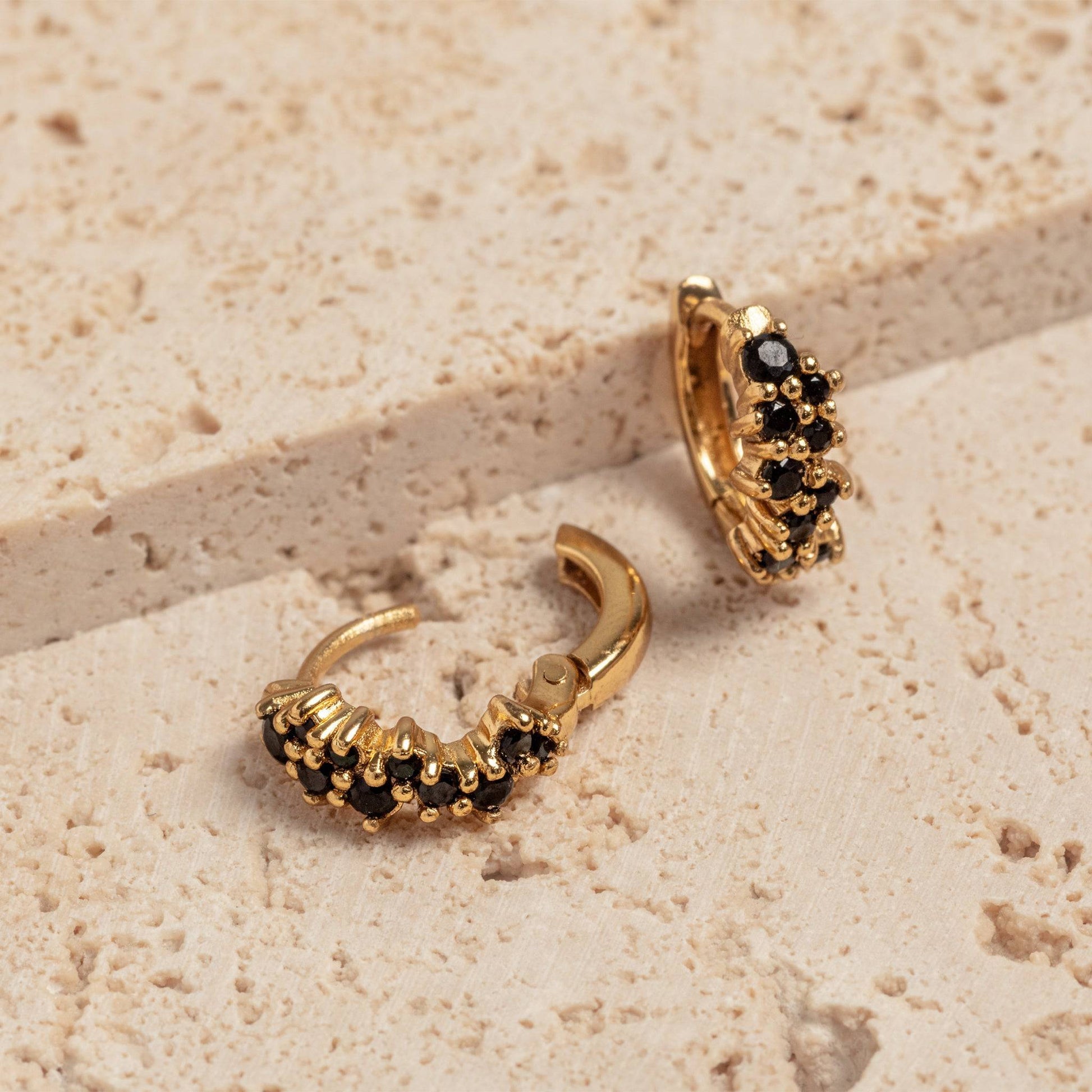 18k gold vermeil and black cubic zirconia scatter huggie hoop earrings, one shown open 