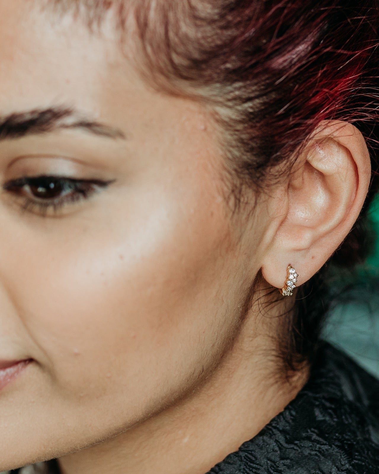 model wears Galaxy Sparkly Gold Huggie Earrings