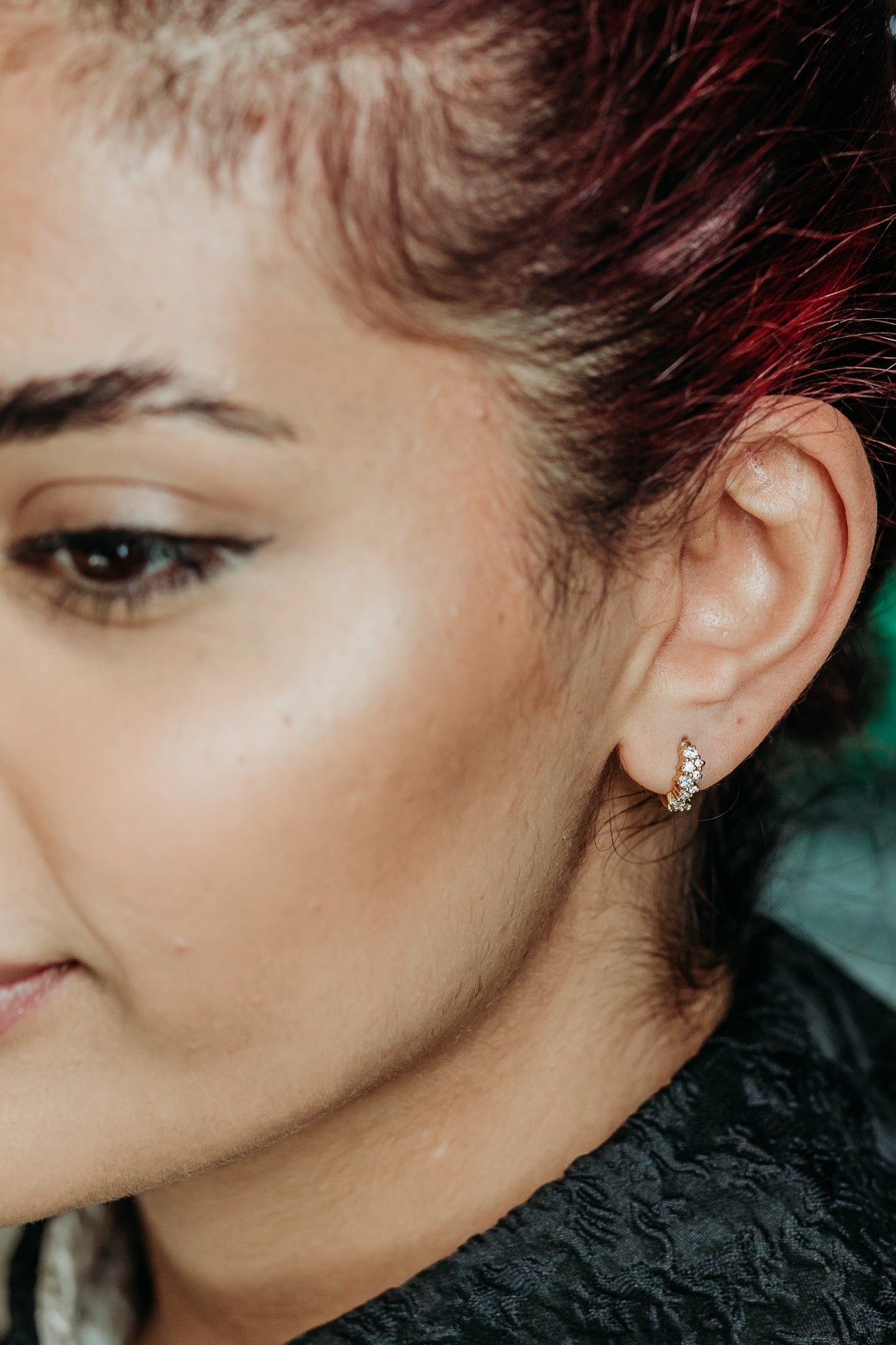 model wears Galaxy Sparkly Gold Huggie Earrings