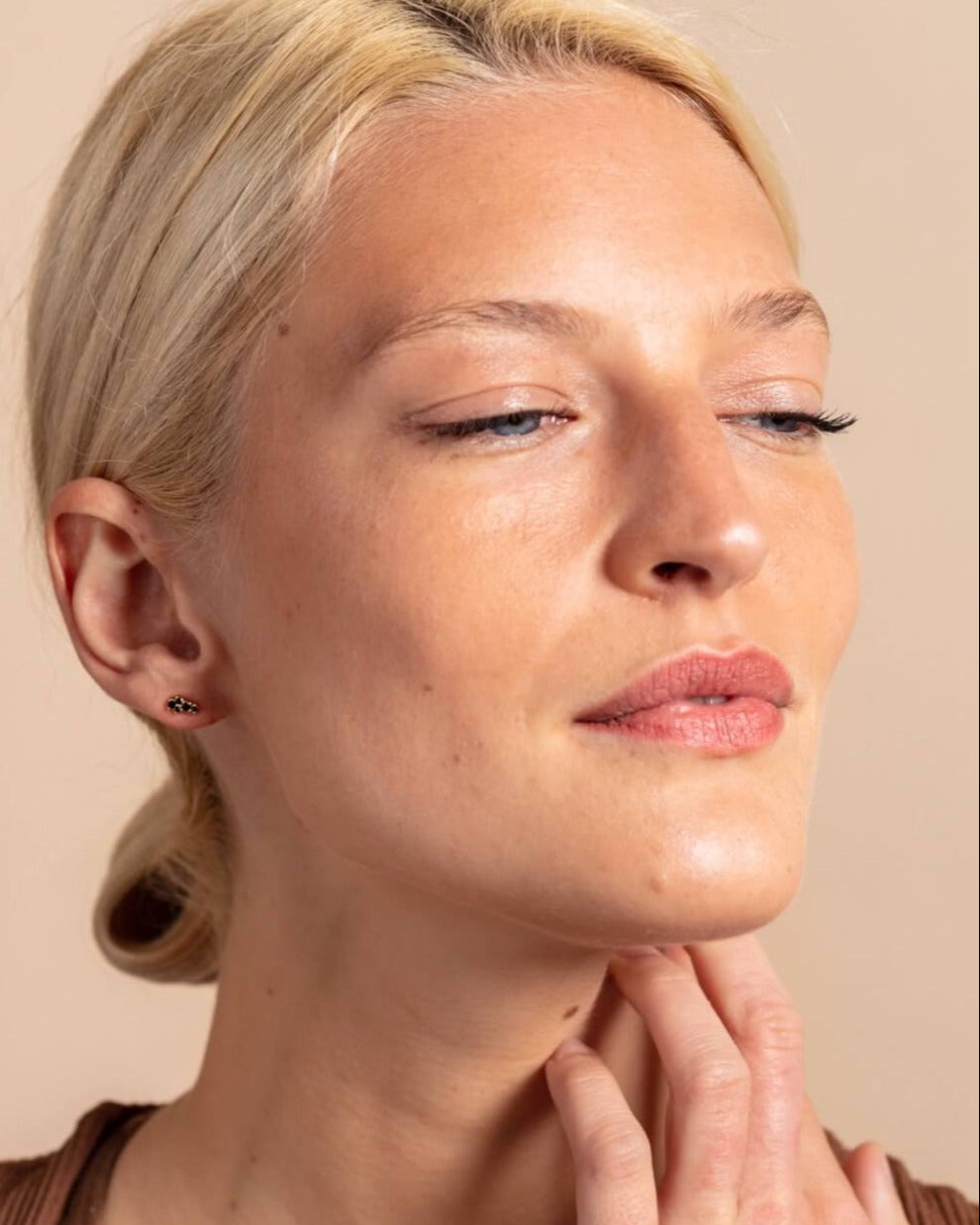 model wears 18k gold vermeil and black cubic zirconia mini stud earrings
