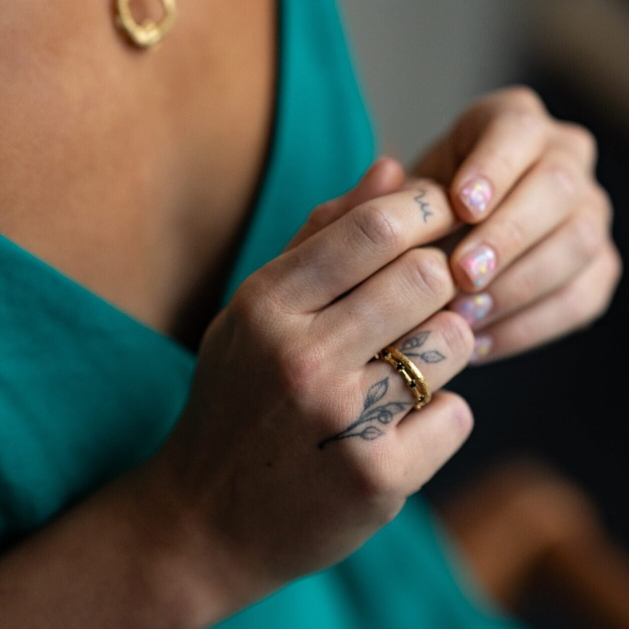 model wears 18k gold vermeil and black cubic zirconia studded dainty stacking ring and 18k gold vermeil antique textured stacking ring