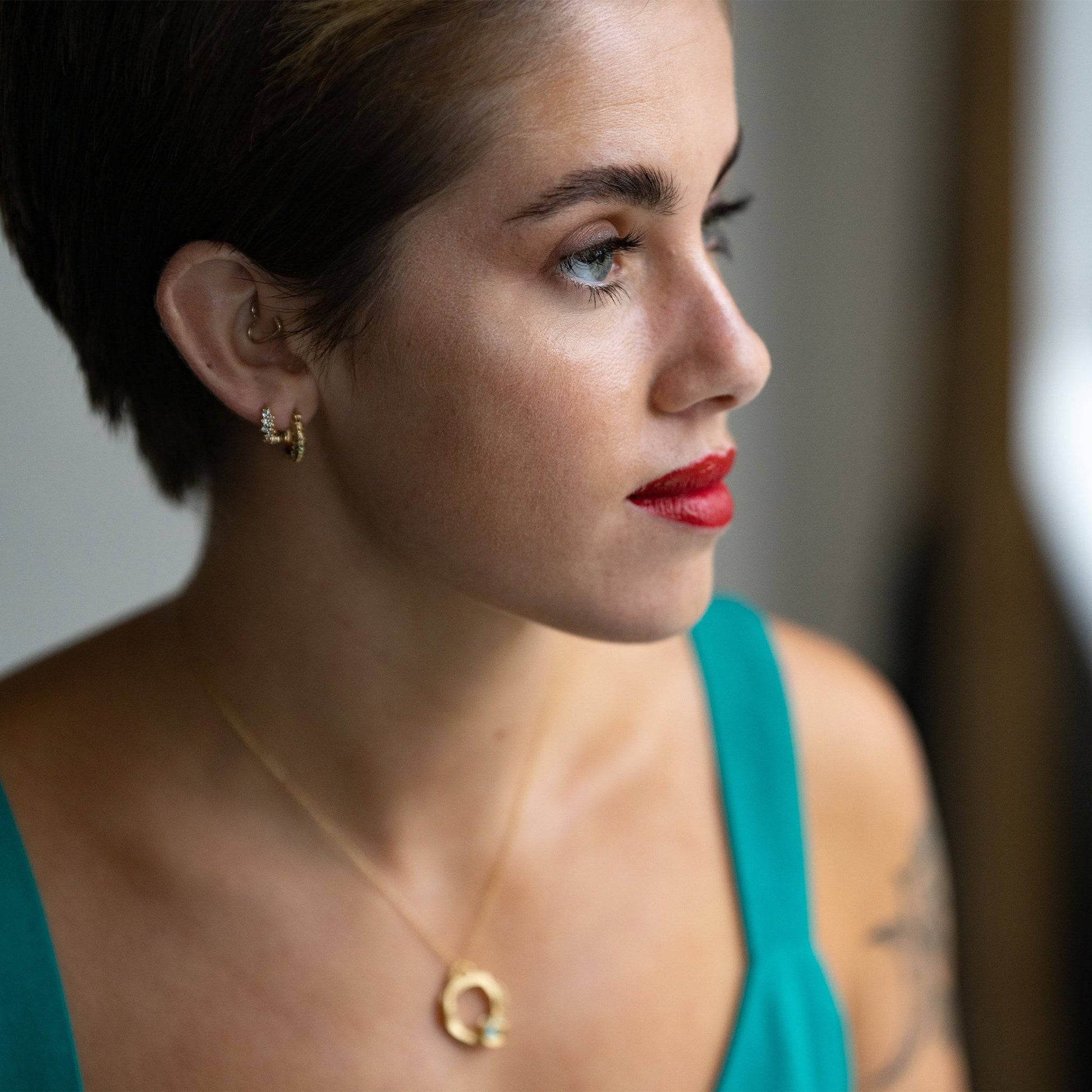 model wears Galaxy Sparkly Gold Scatter Huggie Hoop Earrings