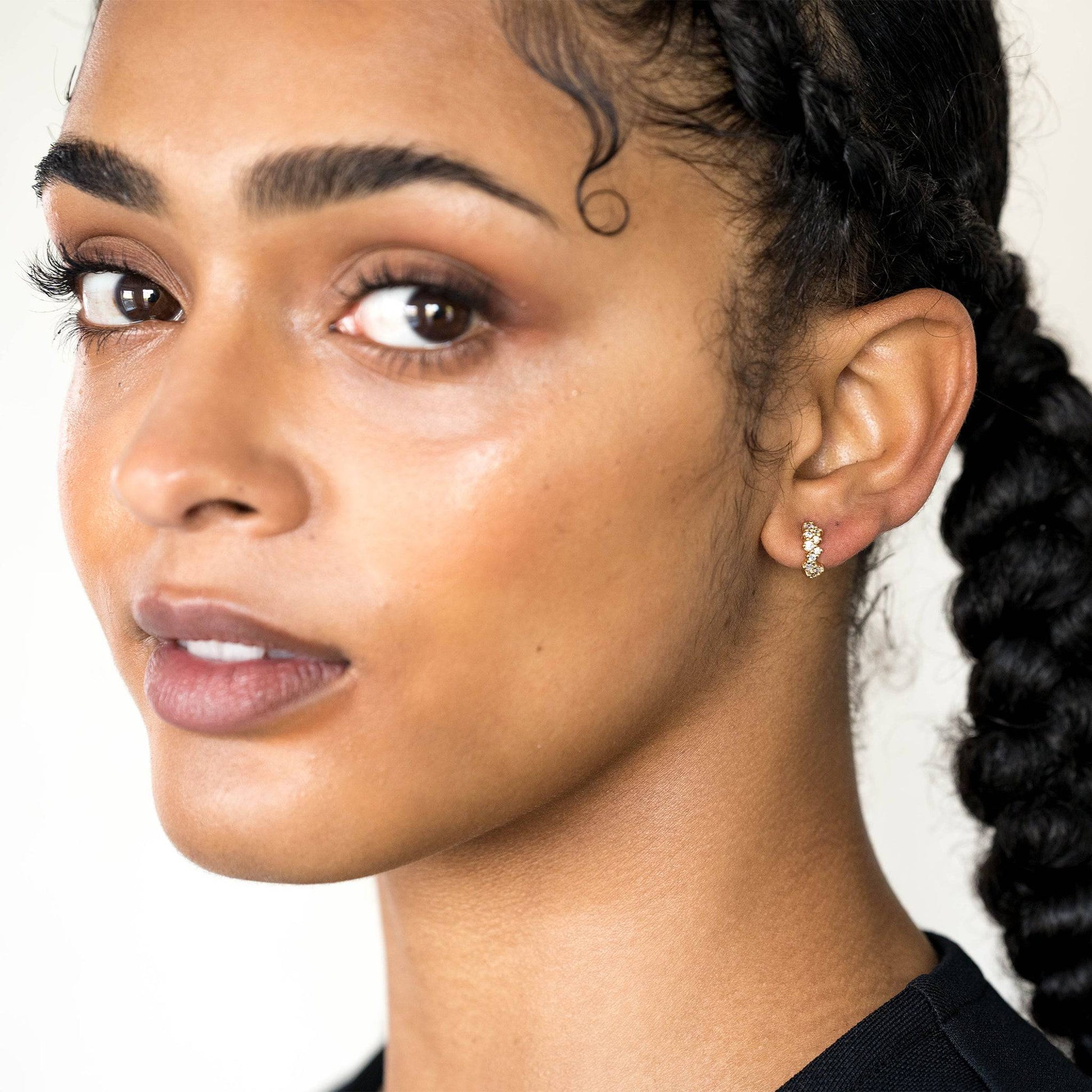 model wears Galaxy Sparkly Gold Scatter Huggie Hoop Earrings