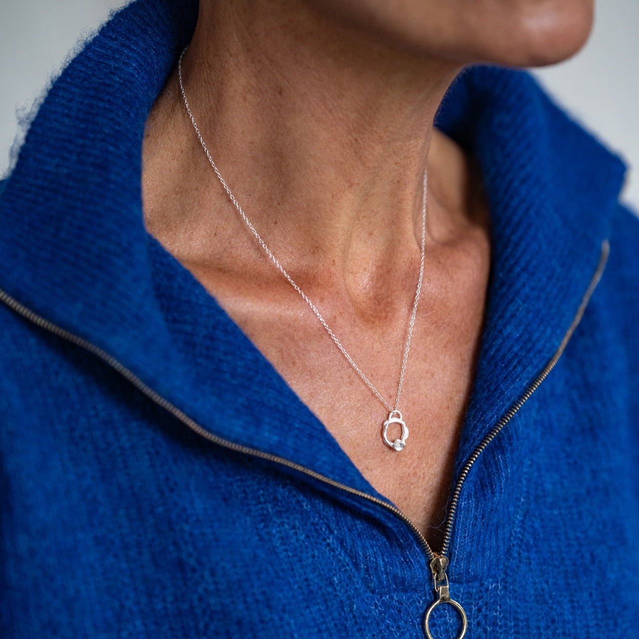 all-groups Celia wears small white topaz silver birthstone necklace