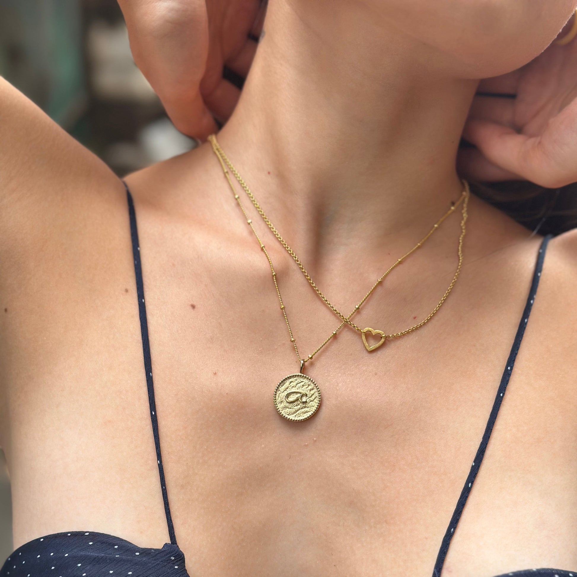 model wears “Fuck” Gold Shorthand Coin Necklace