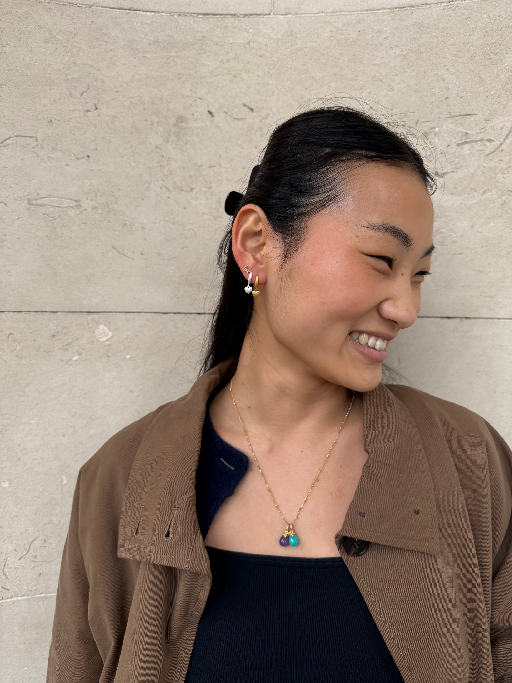 Jade wears Brushed Heart Silver Huggie Hoops