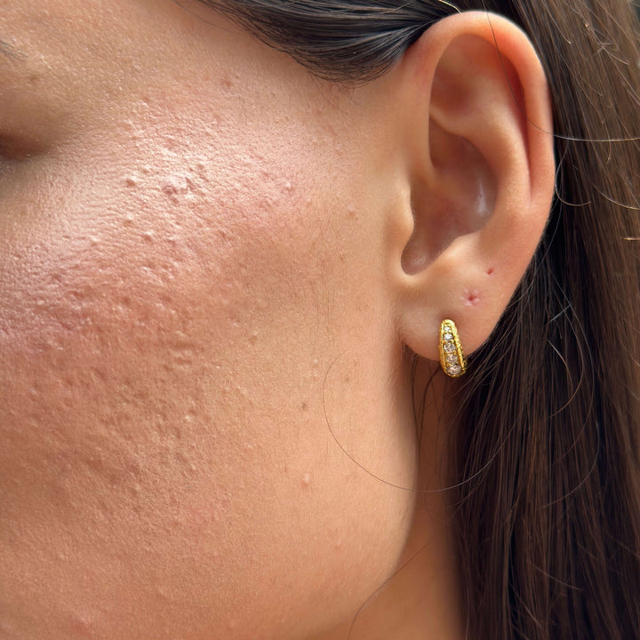model wears Lab-grown diamond antique gold huggie hoops