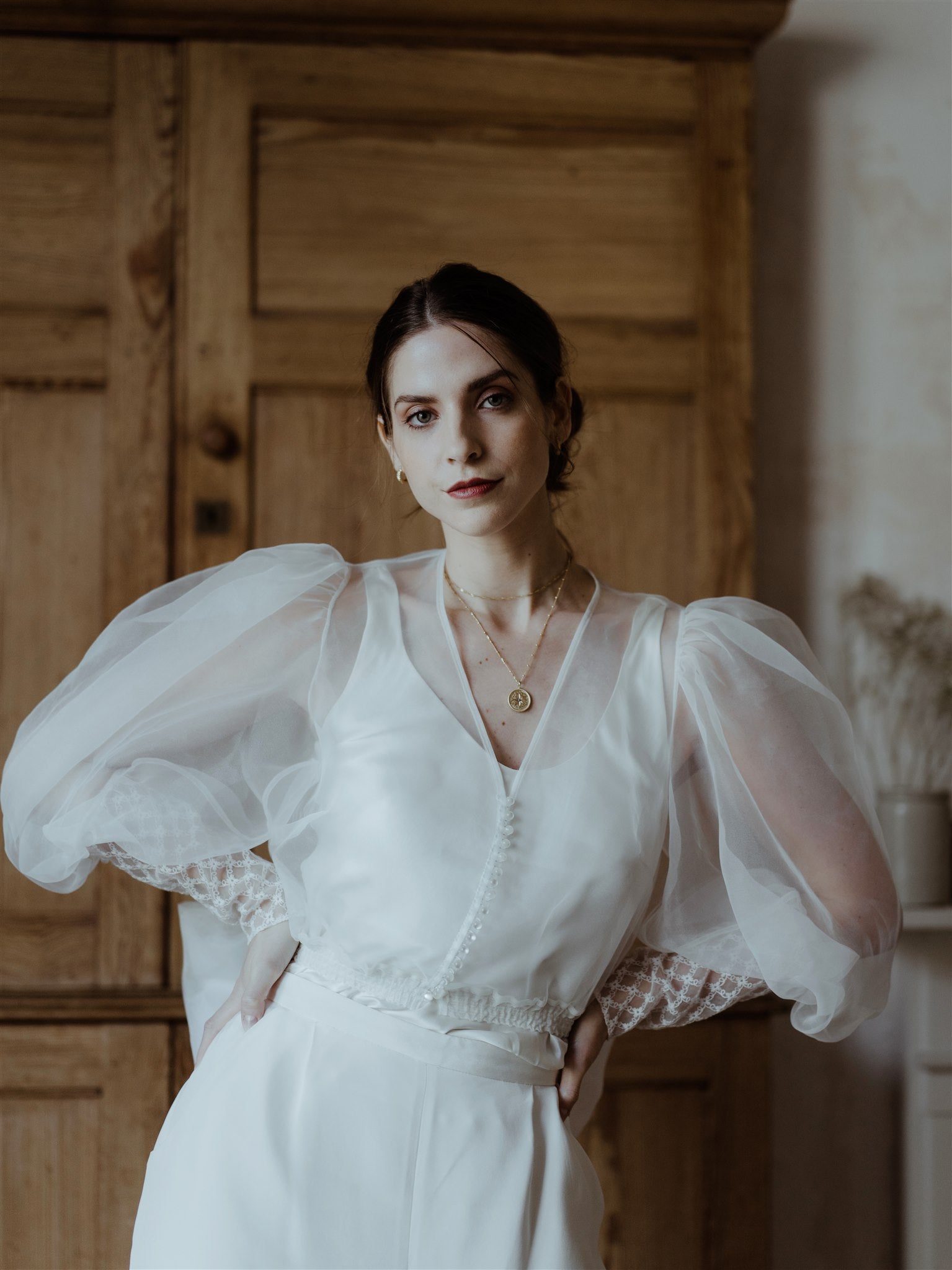 Bridal Model wears chunky gold vermeil diamond cut hoop earrings, north star gold vermeil pendant necklace and gold vermeil dainty layering chains  
