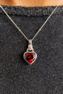 model wears Silver garnet hand in heart necklace on rolo chain