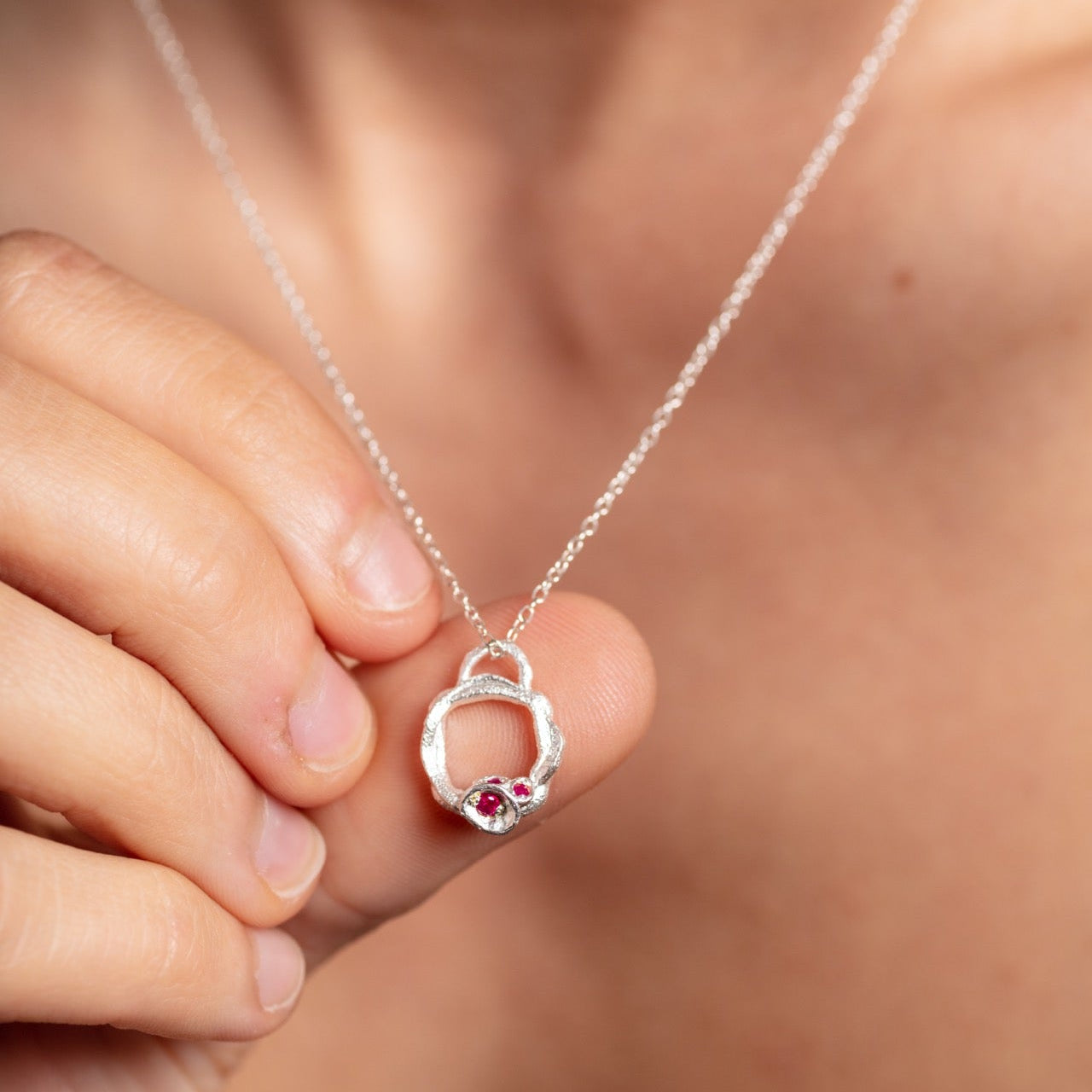 all-groups Laura wears small ruby silver birthstone necklace