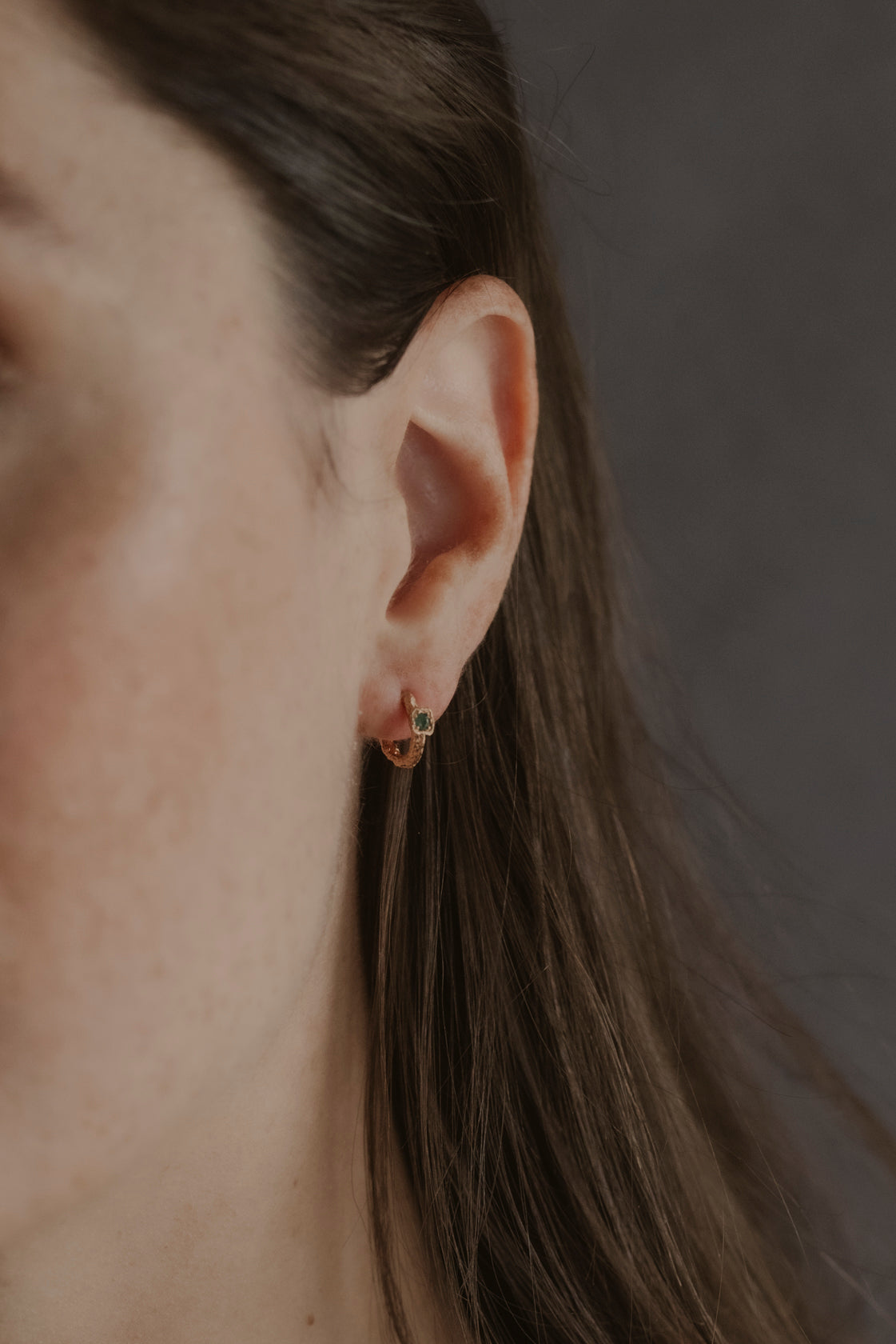 model wears Chalcedony Lichen Branch Gold Huggies
