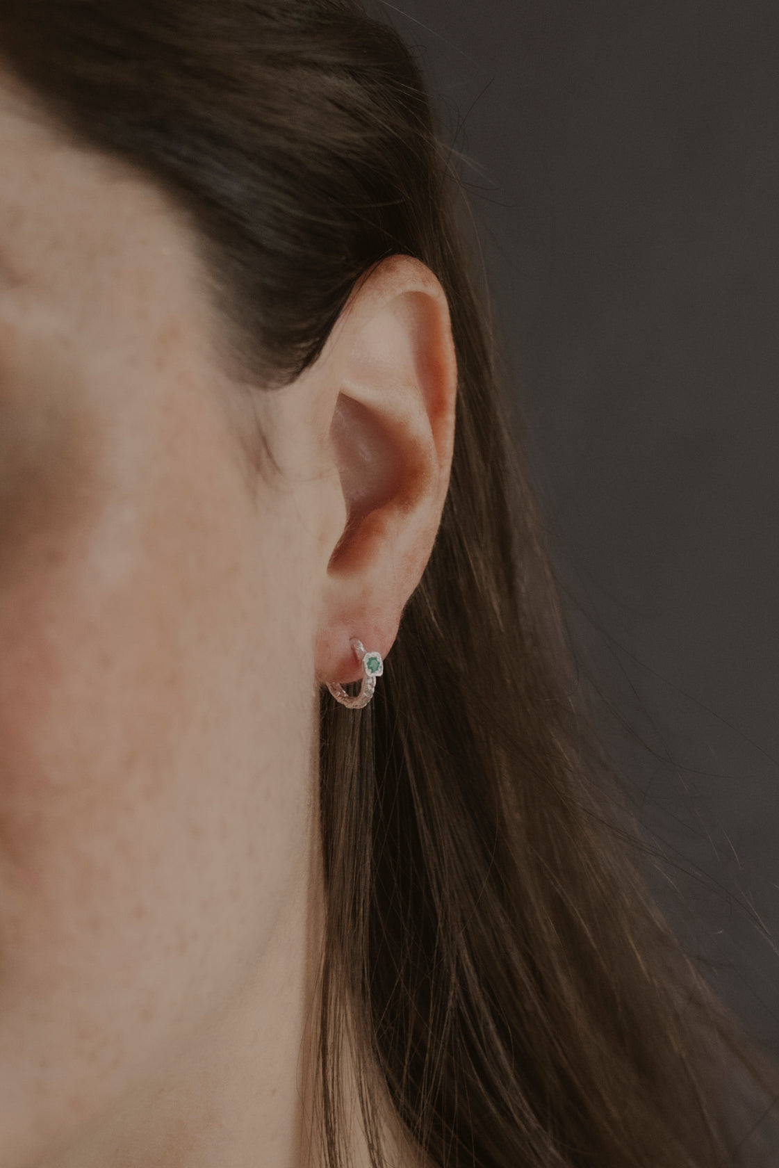 model wears Chalcedony Lichen Branch Silver Huggies