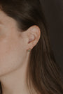 model wears Chalcedony Twisted Branch Gold Huggies